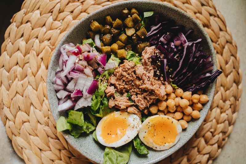 A healthy bowl of salad topped with fresh vegetables